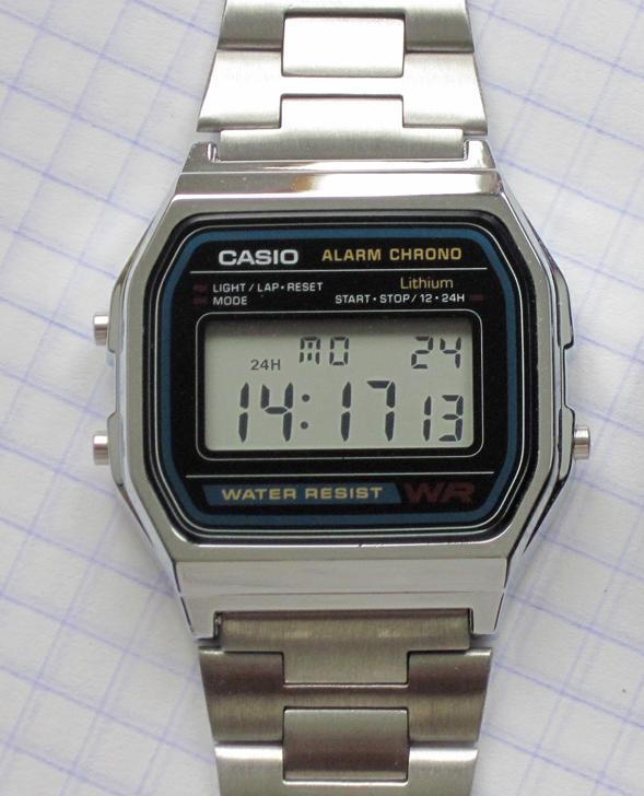 Casio A158W digital watch from the front: chrome-plated case, black and blue face printed Alarm Chrono, Lithium and Water Resist, stainless steel bracelet, display reading 14:17