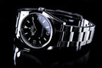 TEST IMAGE. Watch on its side, bezel visible.