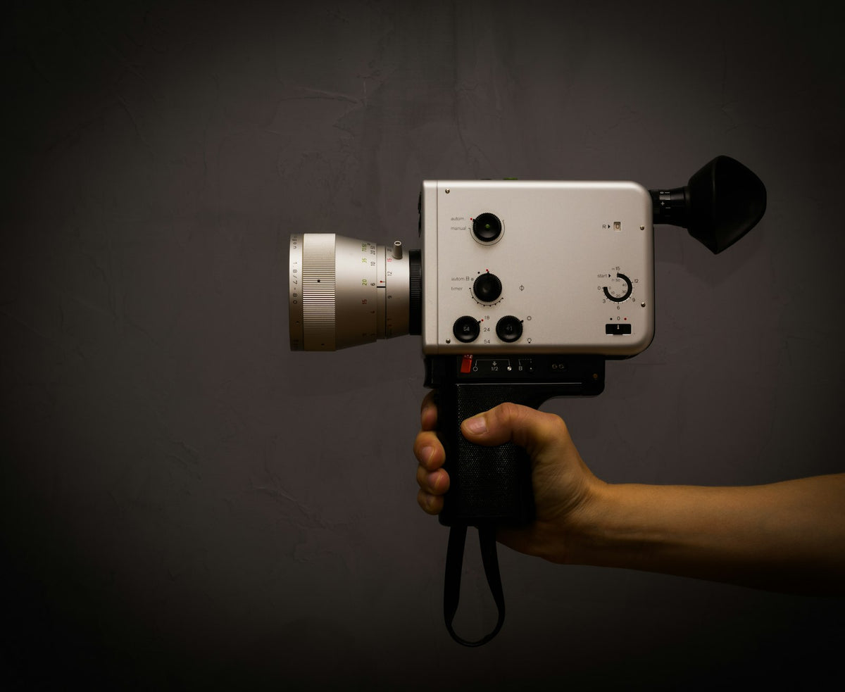 A Super 8 film camera in hand